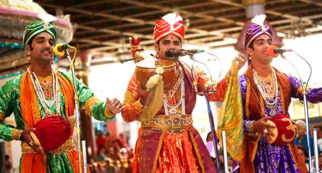 Burrakatha performance at a folk event with artists in costume and stage lighting
